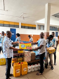 A photo of the school authorities receiving the items