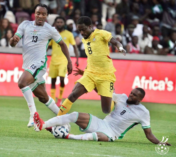 Ashimeru in a duel against two Nigerian players during the game