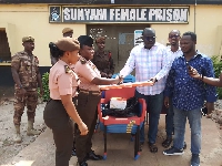 The MP (right) making a donation to the Sunyani Female Prisons