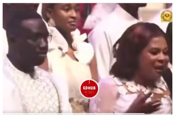 A photo of the couple speaking at a thanksgiving service at church