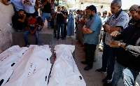 Mourners at a family's funeral in Deir el-Balah