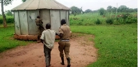 A policeman drags a teacher of Ejome Primary School in Uriama Sub-county