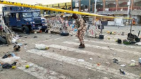 A soldier inspects the aftermath of Monday's bomb blast at a market in Maiduguri, Nigeria