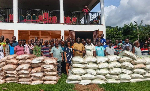 Manfred Tawiah DCE  Afadzato South (9th from left) pose for a photo with farmers