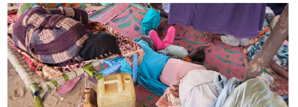 Sudanese women who fled intense fighting in al-Fashir sit at a displacement camp