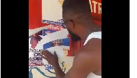 The angry party member removing the poster