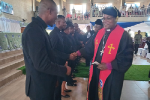 Rt. Rev. Dr. Lt. Col. (Rtd.) Bliss Divine Agbeko in a handshake with the newly inducted pastors