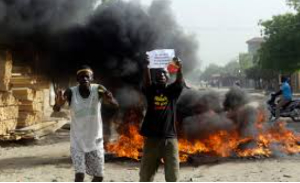 Two men protest on a street in N'Djamena, Chad, Tuesday, April 27, 2021