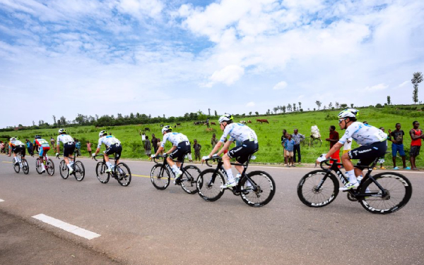 Some people are seen watching cyclists