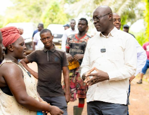 Dr Ato Forson (R) pictured with workers at the Benso Oil Palm Plantation