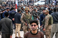 Security personnel stand guard outside the mosque following the deadly blast