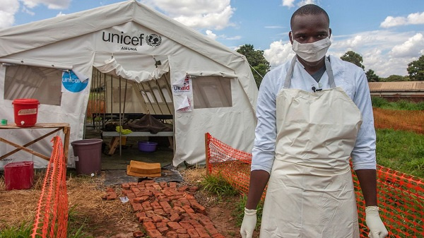 A medical officer in front of a Malawi Cholera Treatment Centre