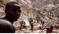 Labourers work at an open shaft of the SMB coltan mine near the town of Rubaya