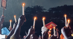 Some protestors holding candle lights amid rainfall