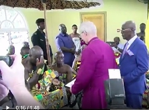 Otumfuo Osei Tutu II making the sign of the cross in front of the Archbishop of Canterbury