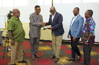 Dr Emmanuel Akwetey (2nd from left), presenting the memorandum to Prof Kwesi Prempeh