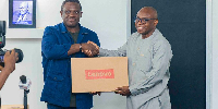 Samuel Nartey George (L) presenting the laptops