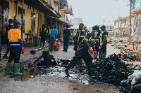 Workers desilt a clogged drain