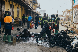 Workers desilt a clogged drain
