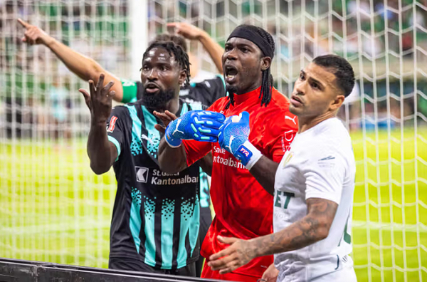 Lawrence Ati-Zigi (in red) during his clash with Slask Wroclaw fans