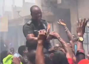 Inspector Hance Atubra being celebrated by residents after rescuing victims from fire