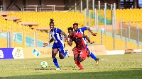 Accra Great Olympics and Asante Kotoko in a hard tackle for the ball