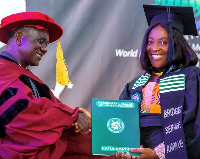 Bridget Serwaa Kwakye is receiving an award after completing a Diploma in Naturopathy