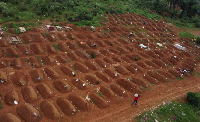 Workers are seen at a cemetery in Ituri province, eastern DRC
