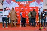 Incumbent MP Sosu (hand raised) with Mahama (second right) during his campaign stop