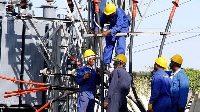 Kenya Power employees repairing a transformer