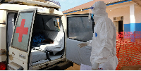 An ambulance transports a patient accompanied by a doctor o the Ebola Virus Disease Treatment Center