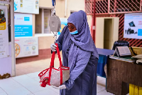 A nurse weighs a newly arrived baby patient at the paediatric hospital stabilization center