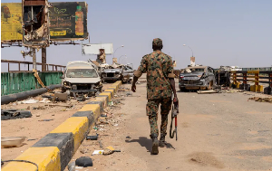 A Sudanese Armed Forces soldier walking on the Shambat Bridge