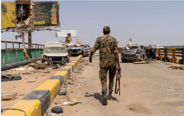 A Sudanese Armed Forces soldier walking on the Shambat Bridge
