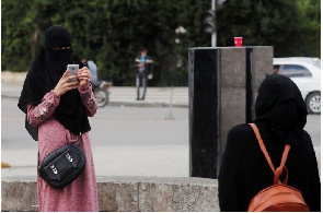 An Egyptian woman wearing a niqab takes pictures in Cairo