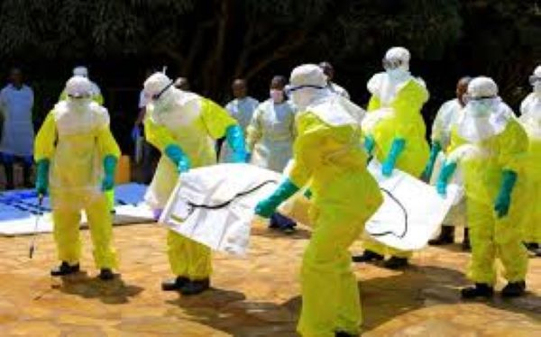 Health workers wearing protective suits take their shift at a treatment centre in Beni,DRC