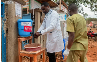 Medics attending to patients sanitise their hands