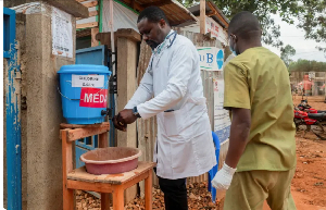 Medics attending to patients sanitise their hands