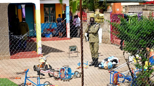 Worried parents gathered outside the school in Kampala after news of the attack spread