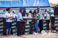 Prof Dr Grace Ayensu Danquah presenting an item to a parent of one of the beneficiaries