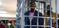 Ugandan opposition leader and four-time presidential candidate Kizza Besigye, stands in the dock