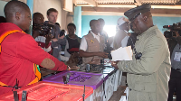 Election official work as Zambians cast their votes at a polling station in Lusaka