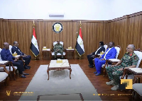 Kwasi Appiah seated with President of Sudan Abdel Fattah Al-Burhan