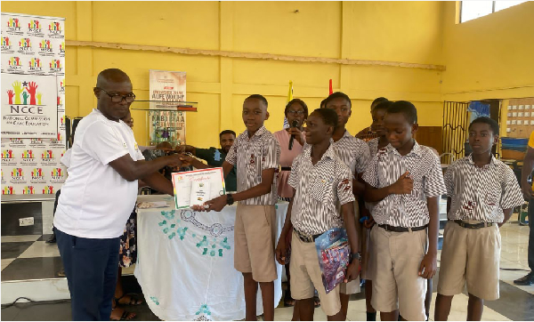 The NCCE Director presenting the contestants with a copy of the 1992 constitution
