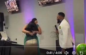 The pastor’s two wives hugging during the introduction