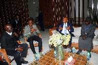 Patrice Motsepe (second from right) engages with Senegalese delegations upon his arrival in Senegal
