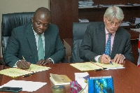 Bryan Acheampong [L] with an official of the UK Government