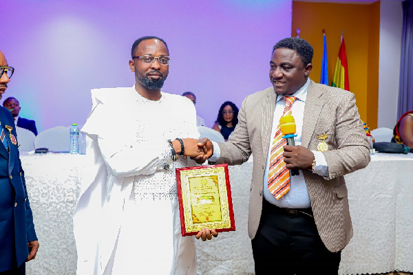 Bishop Samuel Ben Owusu (in white) receiving his official plaque