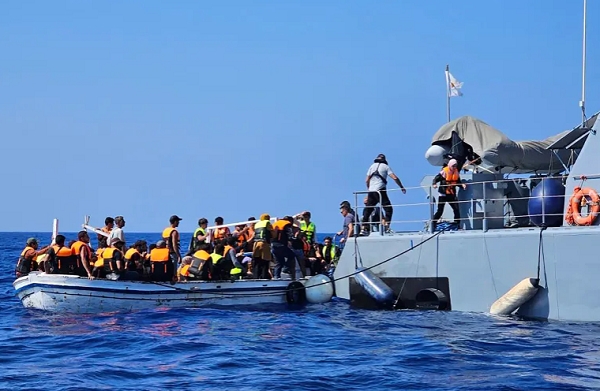This image provided by Cyprus shows its officials helping migrants and refugees in the sea