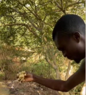 A man offering kenkey as sacrifice to the river god